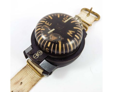WWII ERA WRIST WORN MILITARY COMPASS, LIQUID FILLED WITH CANVAS WEBBING STRAP