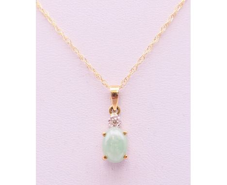 A 9 ct gold jade and diamond pendant on chain. The pendant 1 cm high. 