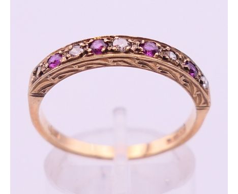 A 9 ct gold diamond and ruby ring. 2.7 grammes total weight. Ring size S.