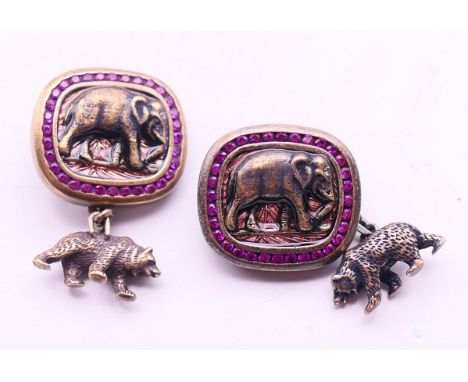 A pair of silver and ruby elephant and bear cufflinks bearing Russian marks.  2 x 1.75 cm. 