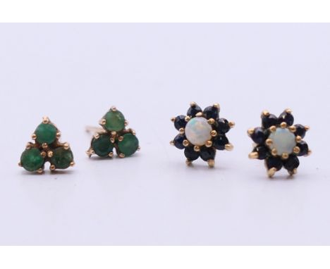 A pair of 9 ct gold sapphire and opal stud earrings and a pair of emerald ear studs. The later 6 mm diameter.  