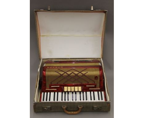 A cased Hohner Virtuola III 120 key accordion. 58 cm wide.