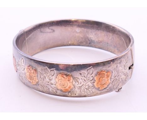 An unmarked gold mounted silver hallmarked bangle form bracelet. 6.5 cm diameter.