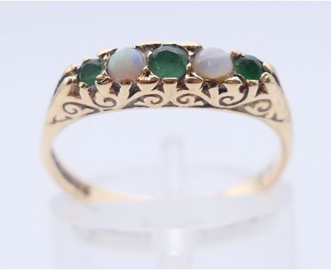 A 9 ct gold emerald and opal ring. Ring size N/O.