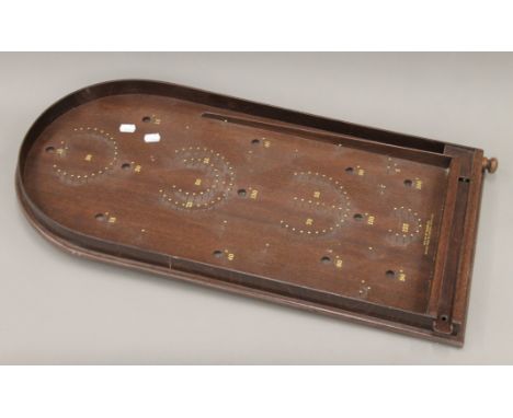 A wooden bagatelle board, marked 'House of Marbles, Bovey Tracey, Devon, England. 75 cm long.