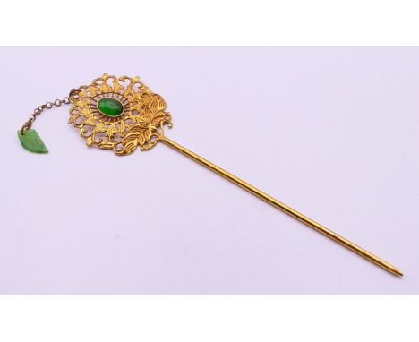 A jade mounted hairpin. 19 cm long.