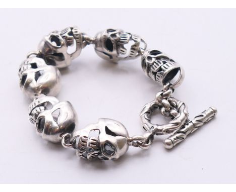 A silver skull bracelet.  20 cm long. 