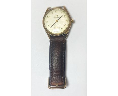 A GENTS WRISTWATCH by Garrard, manual wind, 9ct gold case, presentation inscription 