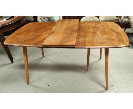 An Ercol Blonde Elm and Beech Grand Windsor dining table, of rounded rectangular form with double hinged leaf, with squared t