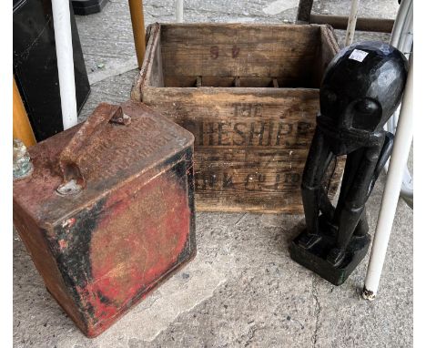 A vintage wooden Cheshire milk crate, metal petrol can and an African carved figure 