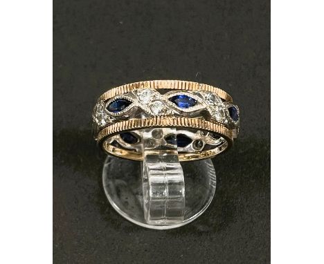 A two tone yellow and white metal dress ring set with blue and white sapphires, 3.6gms, size K 