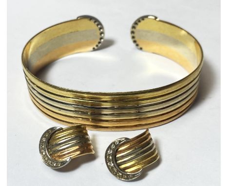 A 3 colour yellow metal bangle or ridged outline, the semi circular terminals each set 9 diamonds, a pair of matching earclip