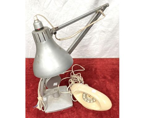 A vintage angle poise lamp; a telephone 