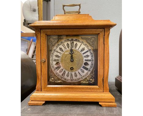 An oak cased mantel clock with chiming Franz Hermle movement 