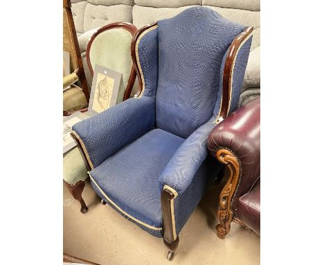 An Edwardian high back armchair with mahogany frame, light blue upholstery 