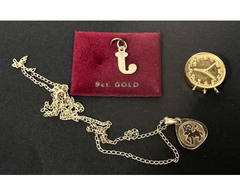 A 9 carat hallmarked gold small triangular pendant on fine chain, stamped '375'; a 9 carat hallmarked gold clock charm, 3.5gm