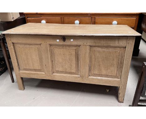 A 19th century oak mule chest with panel front, hinged lid and candle box inside. 