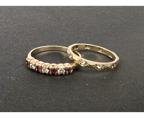 A 9 carat hallmarked gold ring set 3 diamonds and 4 rubies, size M; a small gem set eternity ring, stamped '9ct', size J/K, g