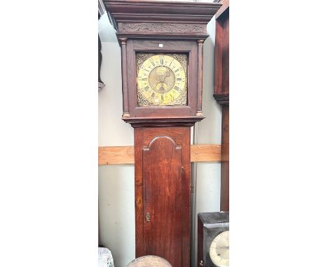 An 18th century longcase clock, the hood with moulded cornice and twin turned side columns, the trunk with full length door, 