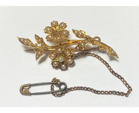 A seed pearl set brooch in the form of flowers and leaves, stamped '18ct', 4.88gm 