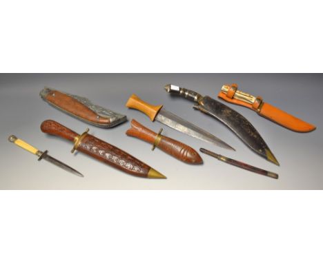 A Kukri knife;  a Sudanese type arm dagger;  a Malcberry 1897 pattern hand forged sheath knife, horn handle, tan leather shea