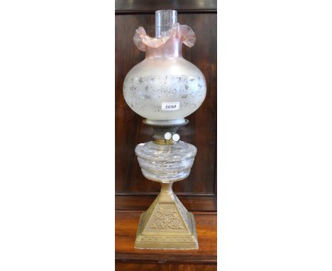 A Victorian brass and clear class oil lamp, tapering reservoir, etched frosted shade