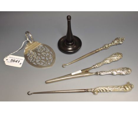 A pair of George V silver hafted glove stretchers, embossed with snowdrops, Birmingham 1913; a silver hafted button hook, roa