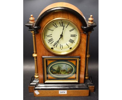 An eight day arch top mantel clock, Seth Thomas, Connecticut, ebonised details, central panel featuring mountainous chalet sc