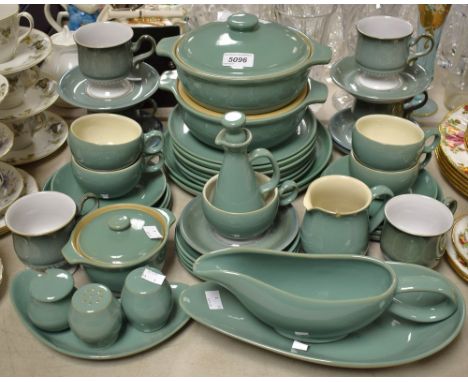 Ceramics - A Denby Manor Green part table service including plates, cups, saucers, oven and casserole dishes, cruet set; etc;