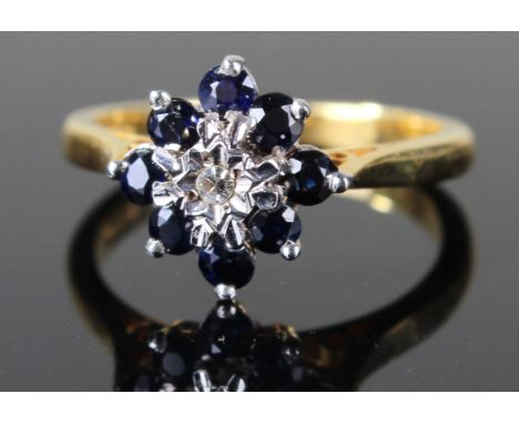 18ct gold ring set with central diamond surrounded by sapphires, size K weight 3.7 grams 