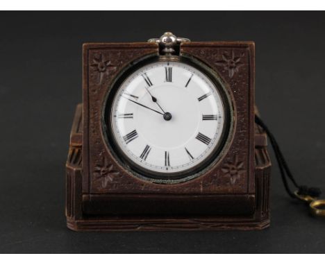 In a carved wooden watch stand, ladies silver open faced pocket watch, enamel dial with black Roman numerals