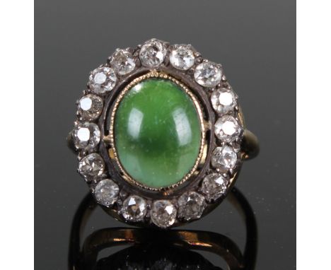 Yellow Metal Ring with central Jade stone surrounded by 16 diamonds approx 1.6 carat, size R, weight 8.9 grams