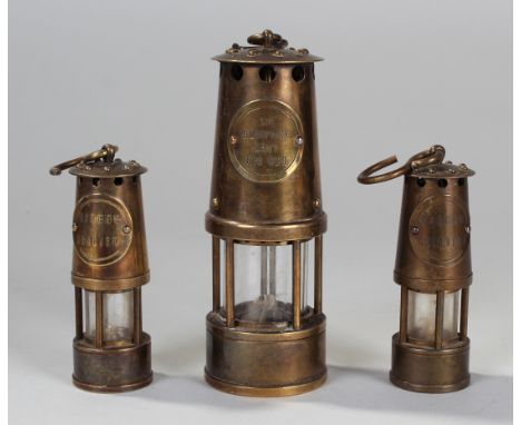 A Miniature Miners lamp commemorating Sir Humphry Davy 1778-1829 (12cm) and smaller pair entitled Barrow Colliery (8.5cm)