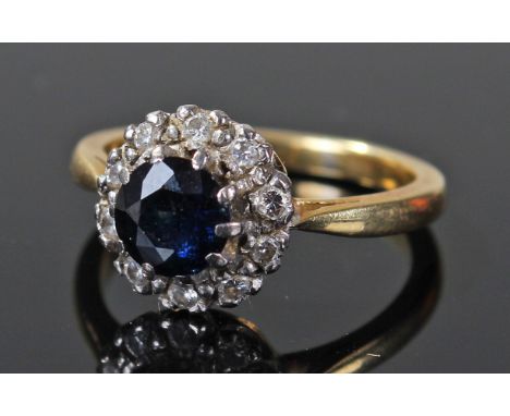 18 carat gold diamond and blue sapphire set ring, centred with brilliant cut blue sapphire, surrounded by ten diamonds, ring 