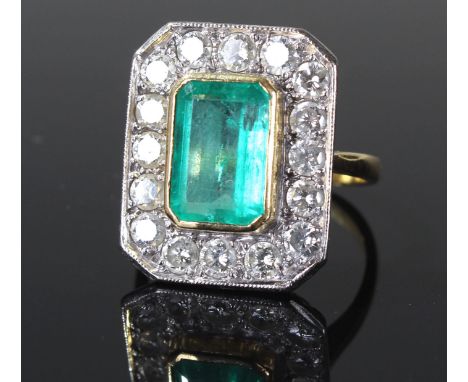 18 carat gold diamond and emerald ring, with a central baguette emerald, surrounded with diamonds on a platinum mount, ring s