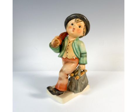 Hand-painted figurine depicting a boy walking with a bag and an umbrella. It was a commemorative piece for the 1935 Leipzig F