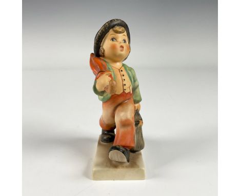 A matte hand painted figure of a boy on route to his destination, carrying an umbrella and a handbag. Goebel backstamp. M.I. 
