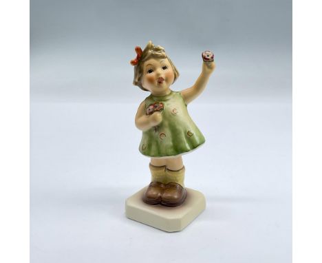 Hand painted figure of a girl in a green dress holding flowers. Goebel backstamp. Includes original box 4.5"L x 3"W x 3.25"H.