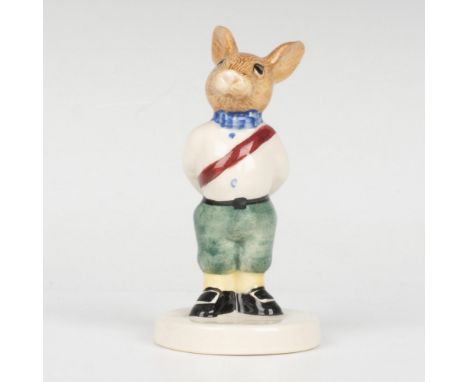 A young royal wearing a white shirt with a dark red sash, and green pants. Part of the Royal Family series. Royal Doulton bac
