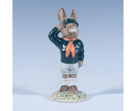 A boy scout saluting and wearing a dark green uniform with gray pants and a red handkerchief. Royal Doulton backstamp. Artist