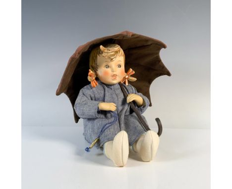 A porcelain and soft body doll of a sitting girl in a soft blue dress holding an orange umbrella. Goebel backstamp on head. T