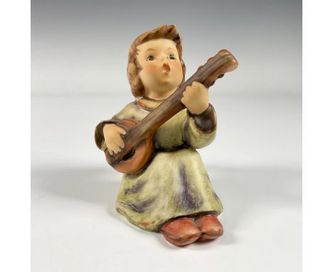 A matte hand painted figure of a sitting angel playing a musical instrument. Goebel backstamp. M.I. Hummel impressed. Artist: