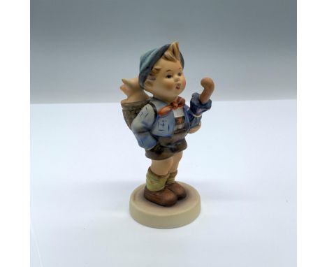 Hand-painted figurine depicting a boy holding an umbrella with a pig in a basket on his back. Goebel backstamp on the bottom.