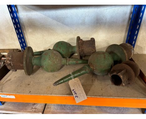 Three large and one small cast iron finial posts. 