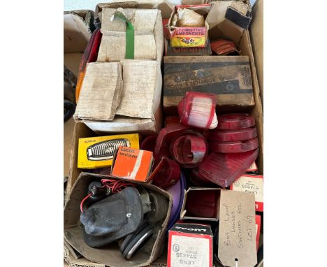 A box of lights, lamp lenses, switches etc. appear new old stock including Lucas, Osram, PMG etc. 