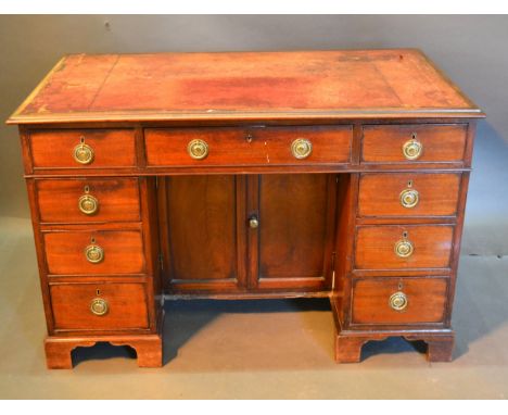 A 19th Century Mahogany Twin Pedestal Desk, the red tooled leather inset top above nine drawers with circular brass handles a