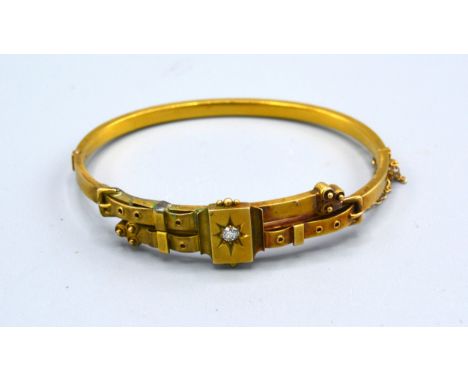 An Edwardian Bangle in the form of a belt with buckle set solitaire diamond 