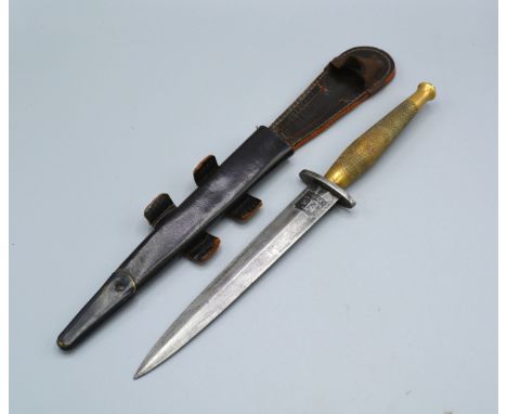 A Fighting Knife, the blade marked FS within leather scabbard 31 cms long 