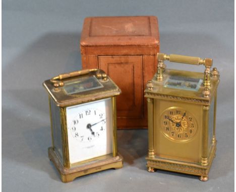 A French Brass Cased Carriage Clock, the dial with Arabic numerals and with lever escapement  and carrying handle together wi