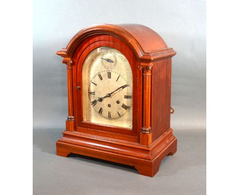 A  Mahogany Mantle Clock By Gustav Becker, the dome top case with arched glazed door flanked by columns with a silvered dial 